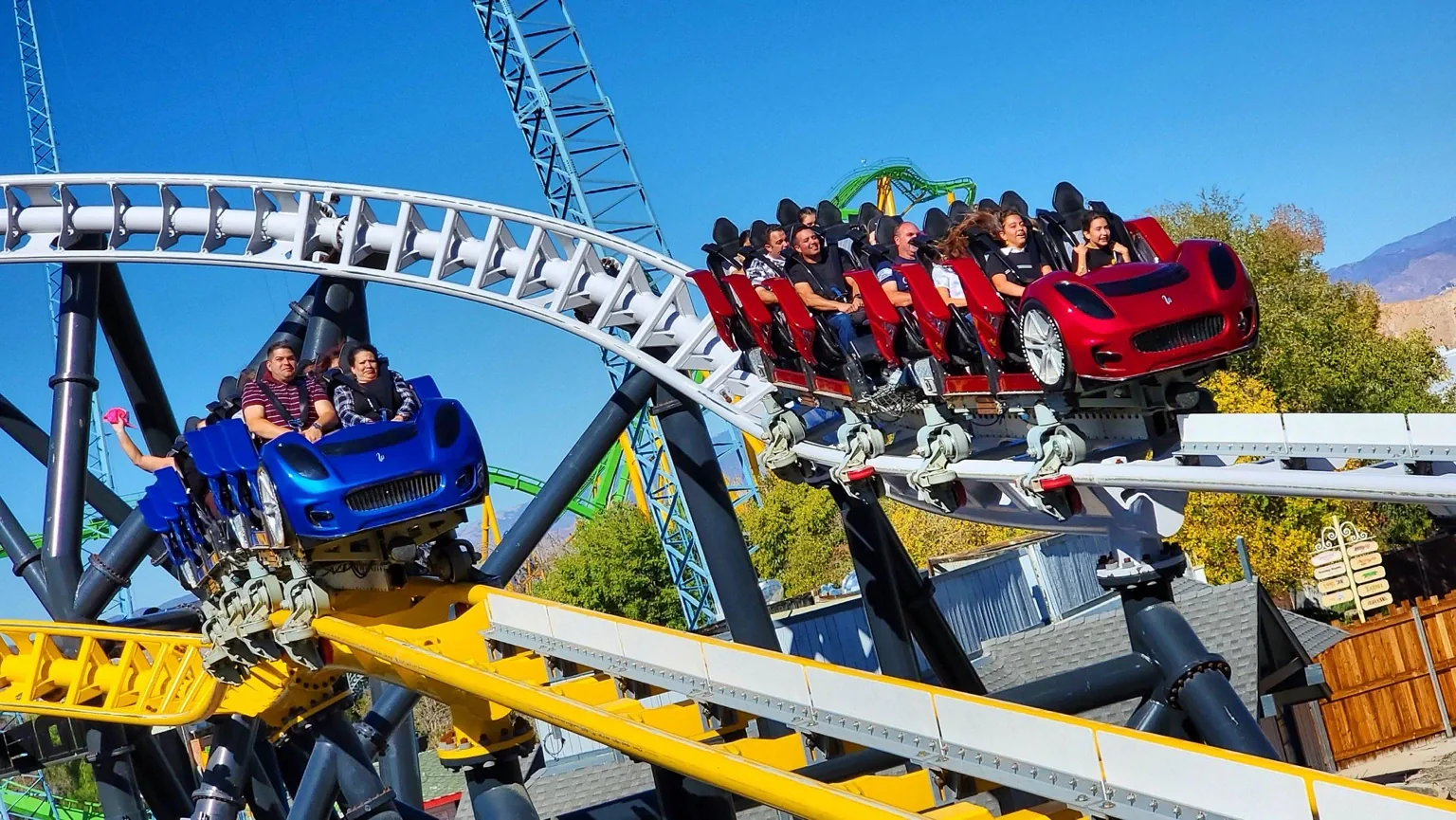 Red and blue West Coast Racers trains carrying riders through parallel turns