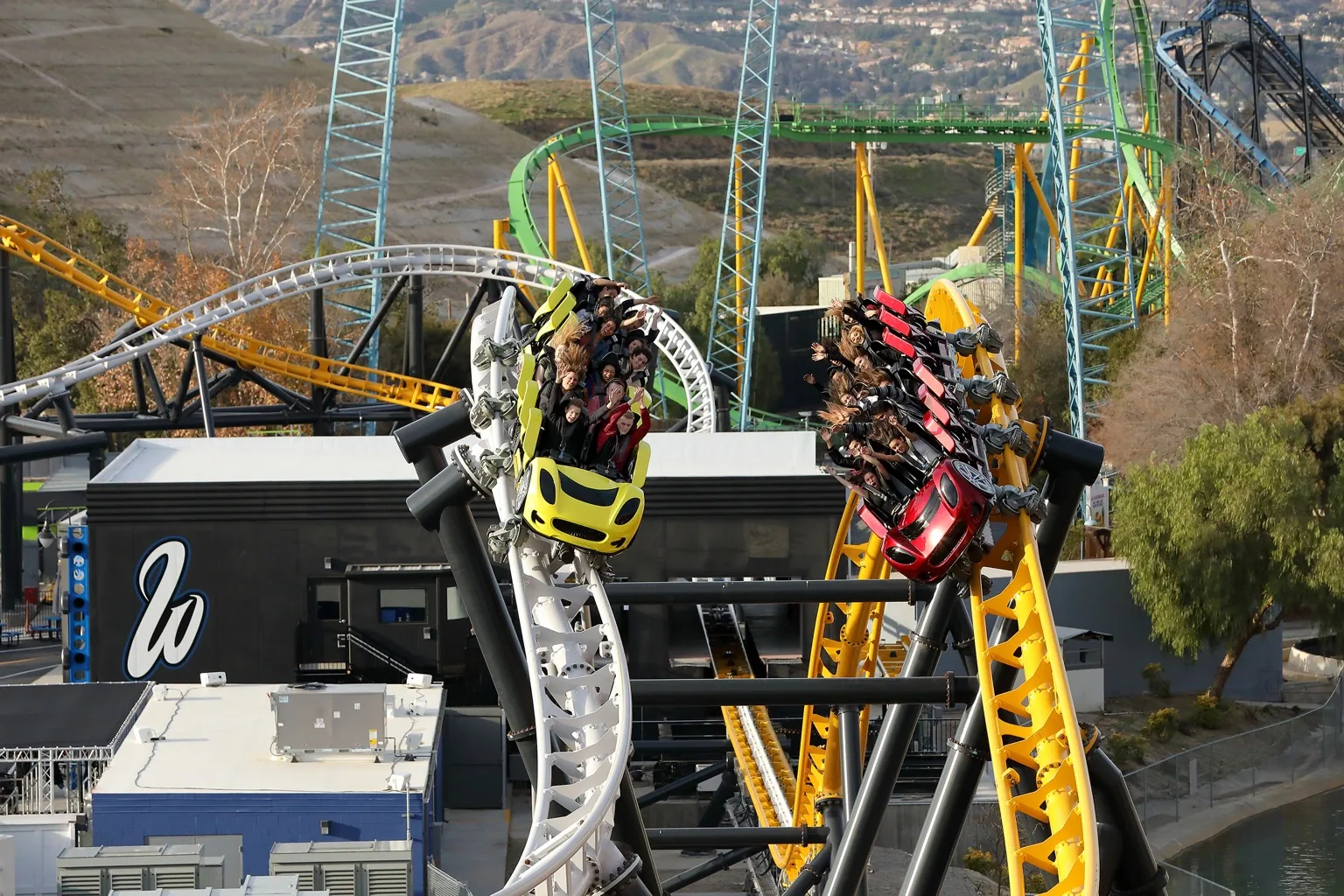 Yellow and red West Coast Racers trains racing side by side at Six Flags Magic Mountain